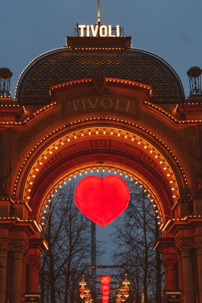 a large heart is lit up in front of a building
