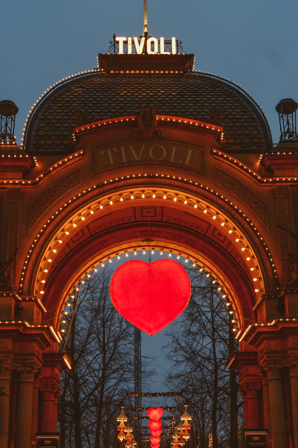 a large heart is lit up in front of a building