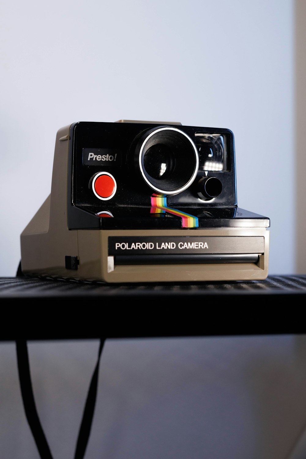 a polaroid land camera sitting on top of a table