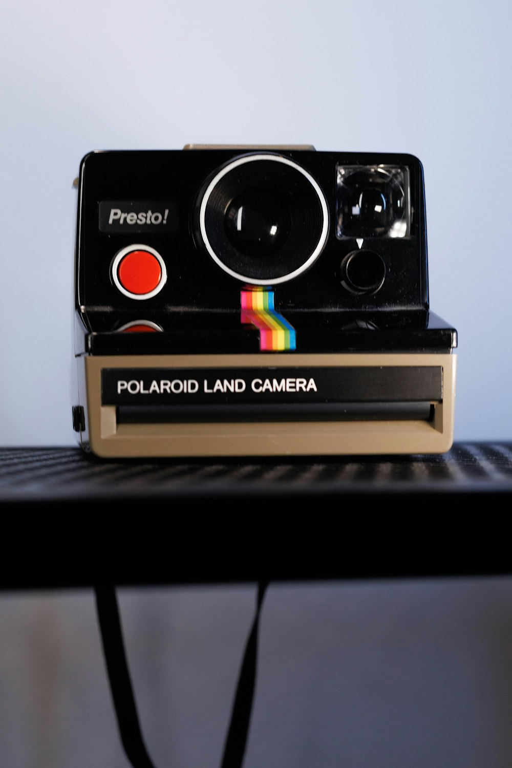 a polaroid land camera sitting on top of a table