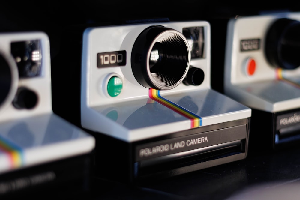 a group of polaroid cameras sitting on top of a table