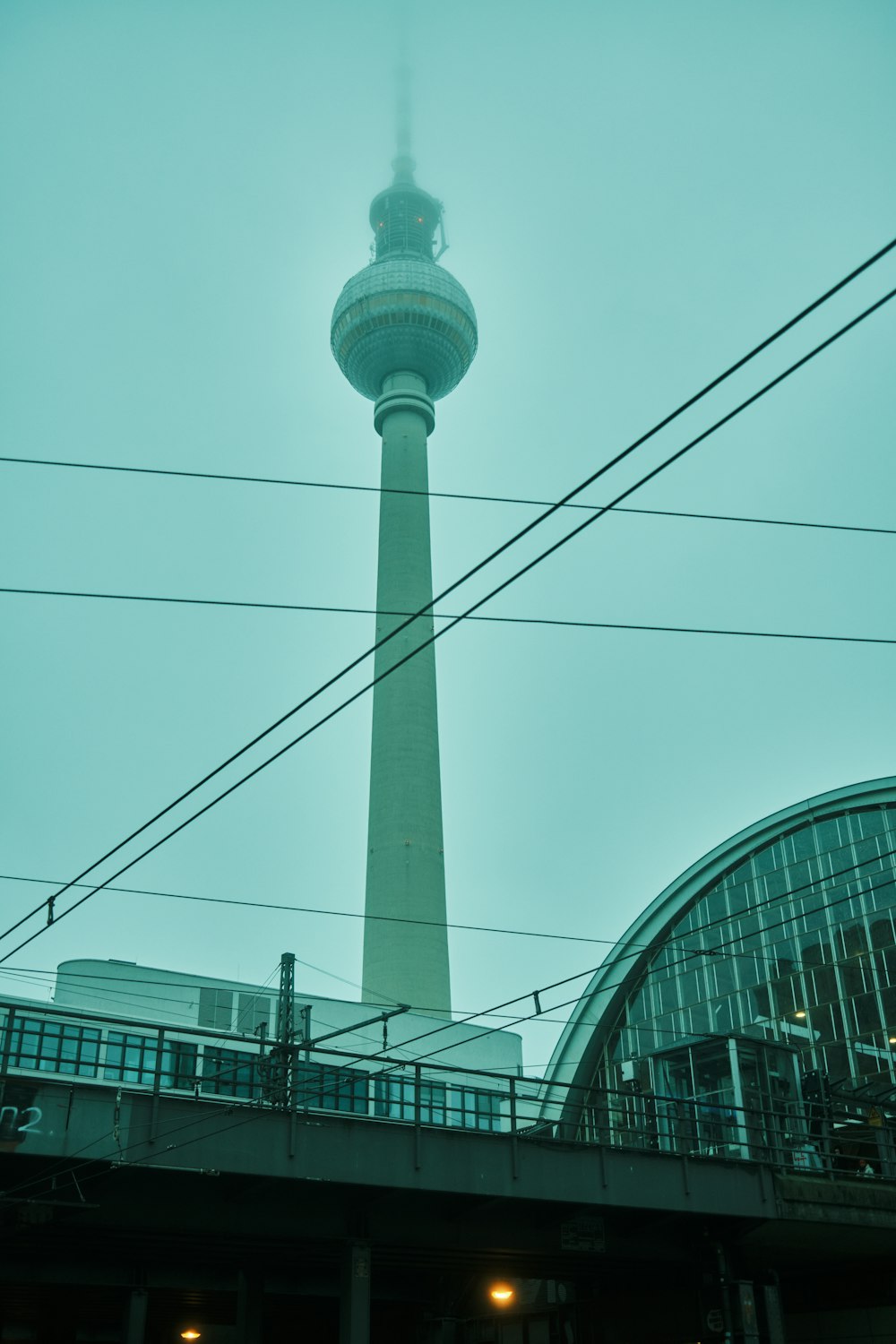 a very tall tower with a sky scraper in the background