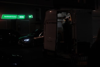 A professional mobile fitter installing a van security lock in a parking lot.