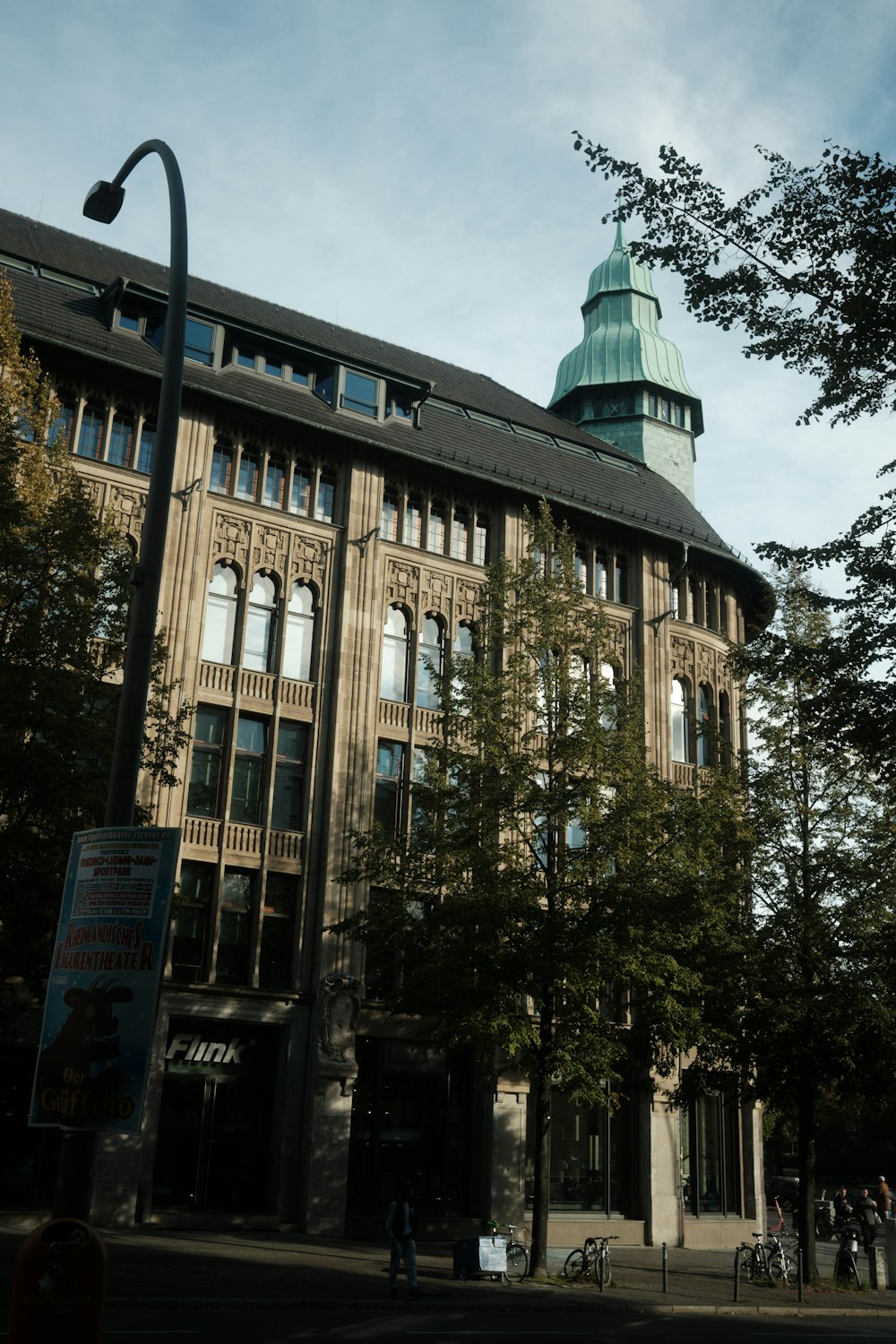 a tall building with a green dome on top of it