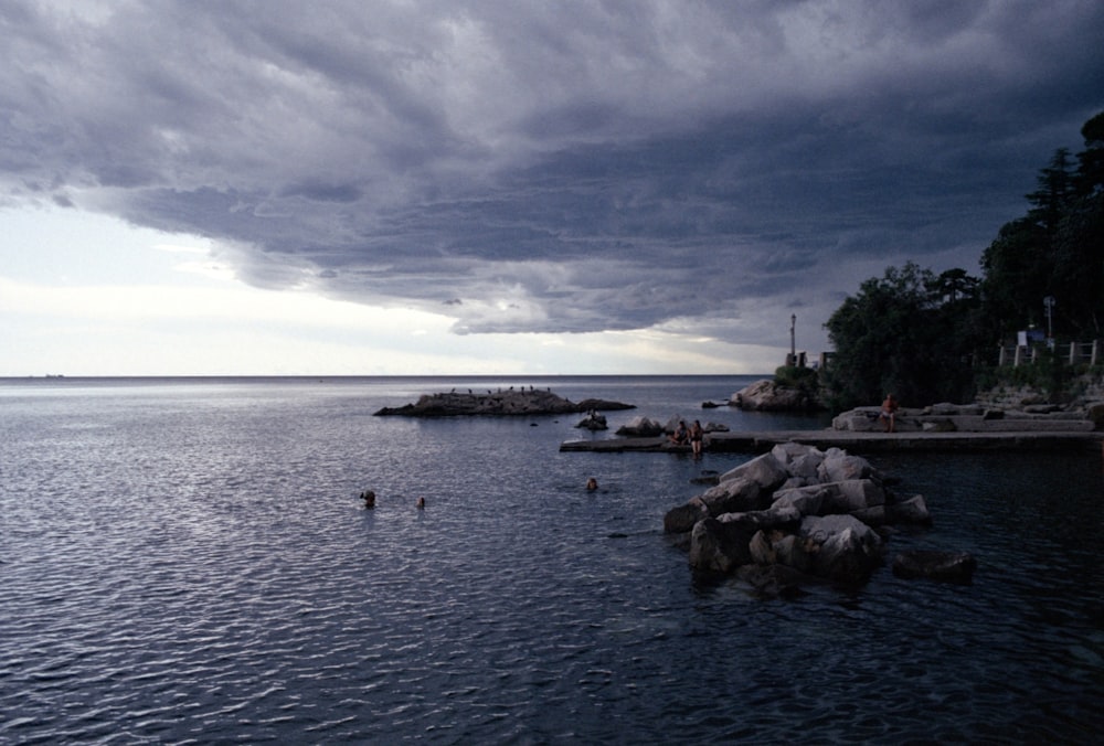 a body of water with rocks in the middle of it