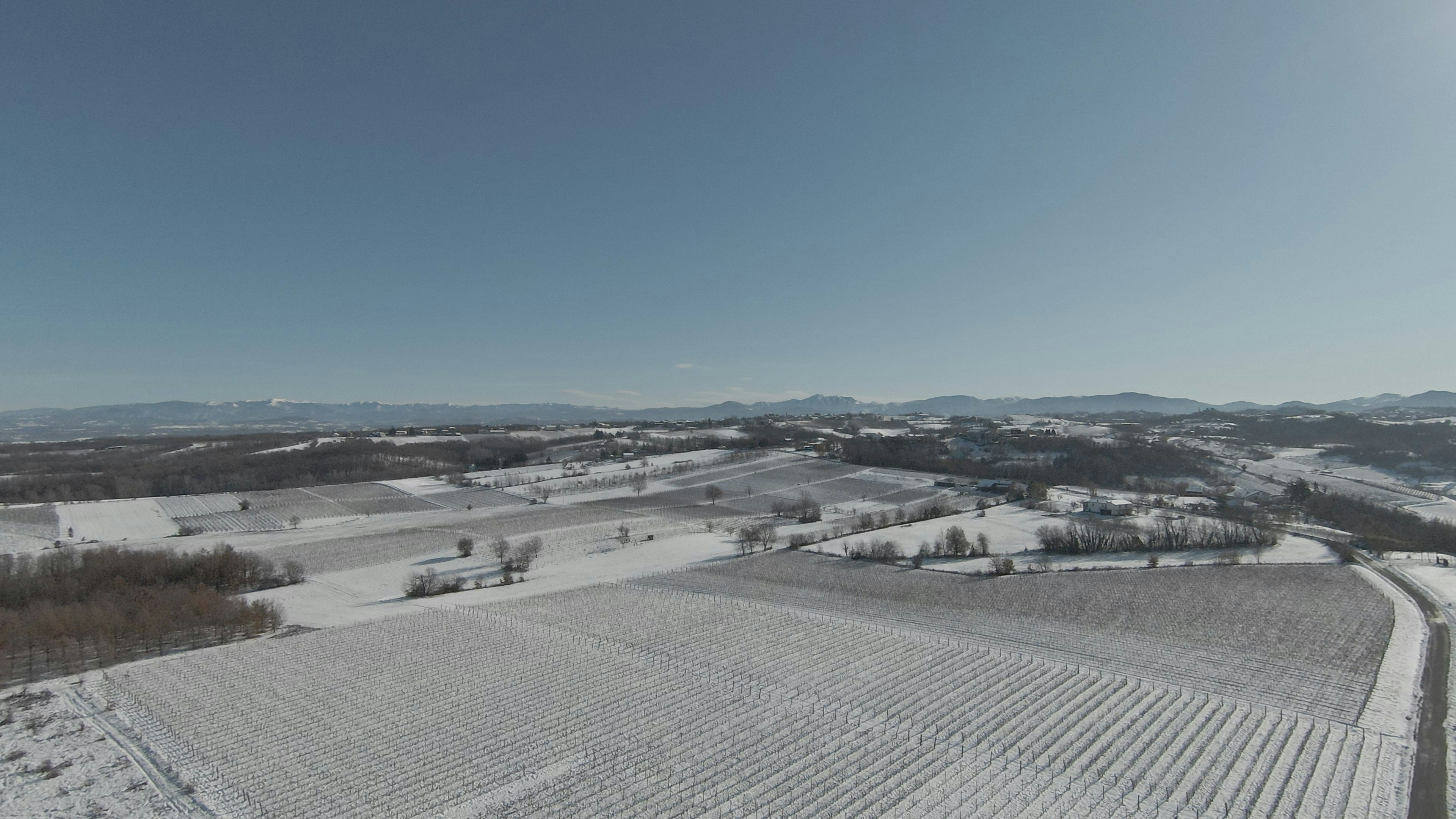an aerial view of a snow covered field