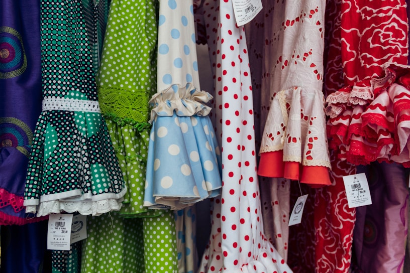 A vibrant collection of girls' frocks displayed in a colorful setting.