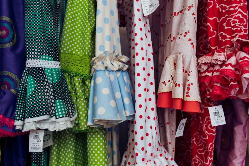 a rack of different colored polka dot fabric