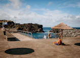 Students and researchers collaborating outdoors near a coastal research station with ocean views