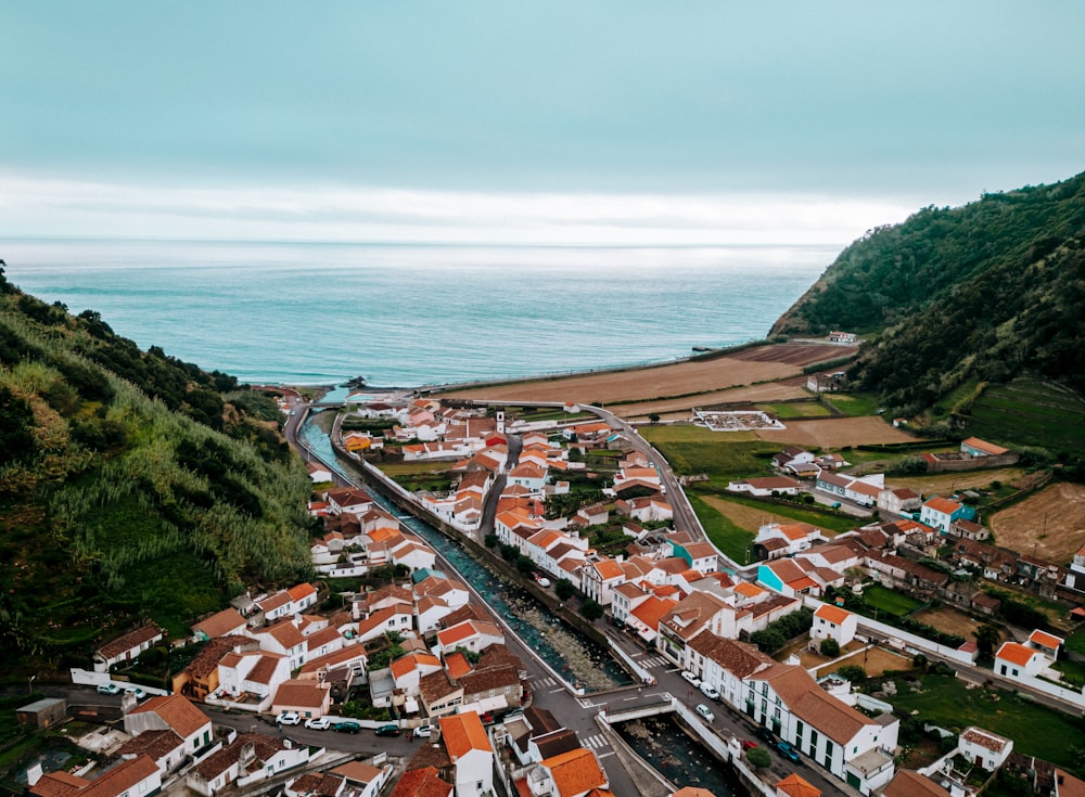 an aerial view of a town by the ocean