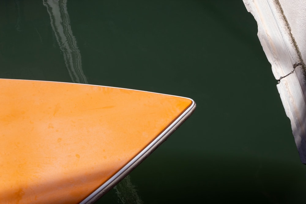 a close up of a yellow boat in the water