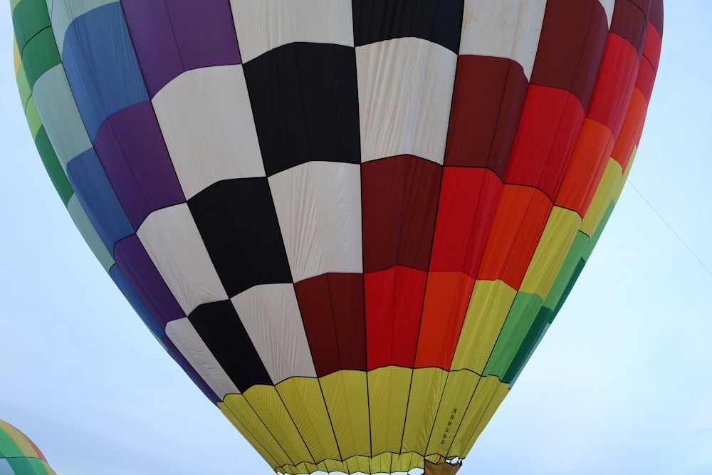 a large multicolored hot air balloon flying in the sky