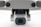 A close-up view of a drone camera, featuring lenses and sensors. The design is sleek and modern with a metallic finish.