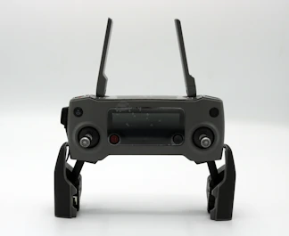 a black device with two handles and two buttons