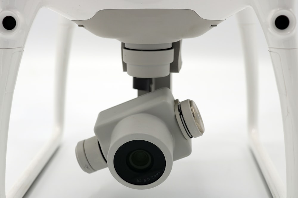 a close up of a camera attached to a white object