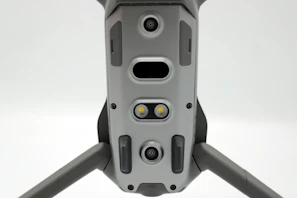 Close-up of a sleek drone casing labeled with part number DC-101, neatly stacked in the warehouse.