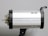 A silver studio light with black accents mounted on a support bracket. The cylindrical shape features small vents and a clear bulb extending from the left side.