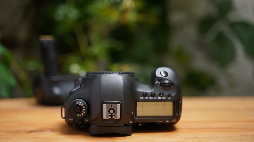 a camera sitting on top of a wooden table