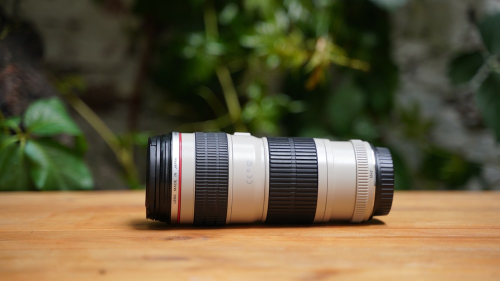 a camera lens sitting on top of a wooden table