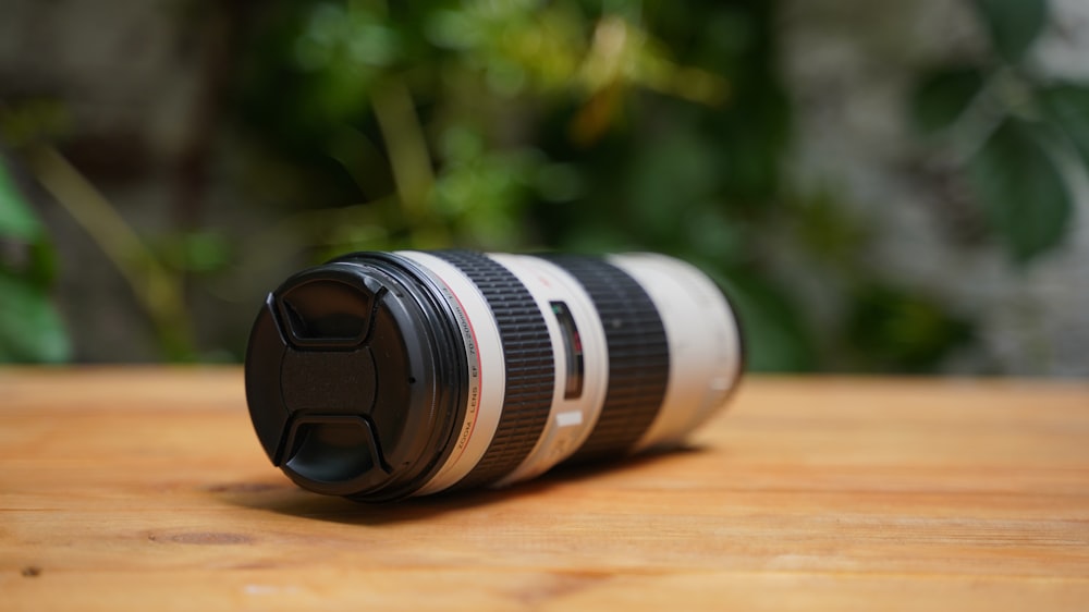 a camera lens sitting on top of a wooden table