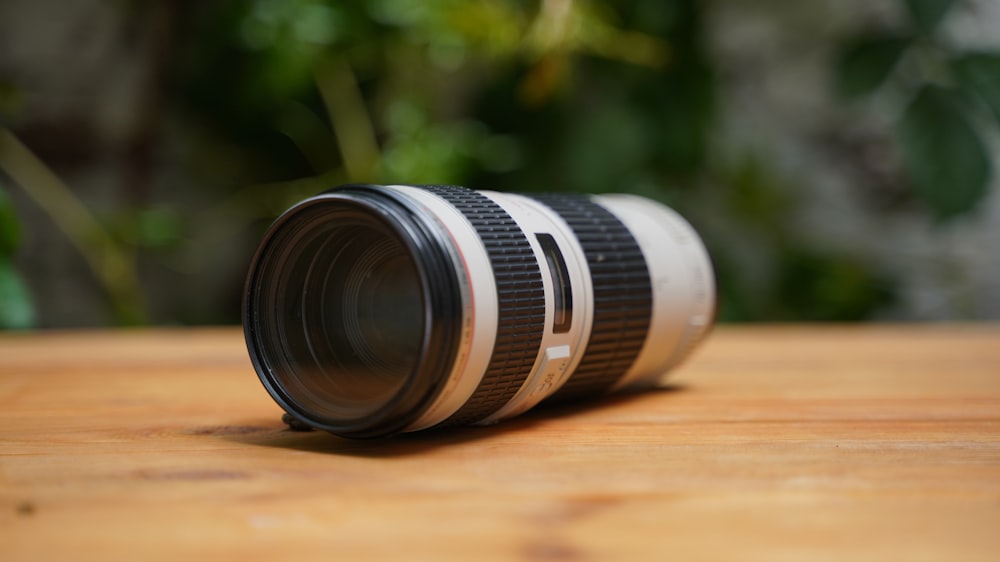 a camera lens sitting on top of a wooden table