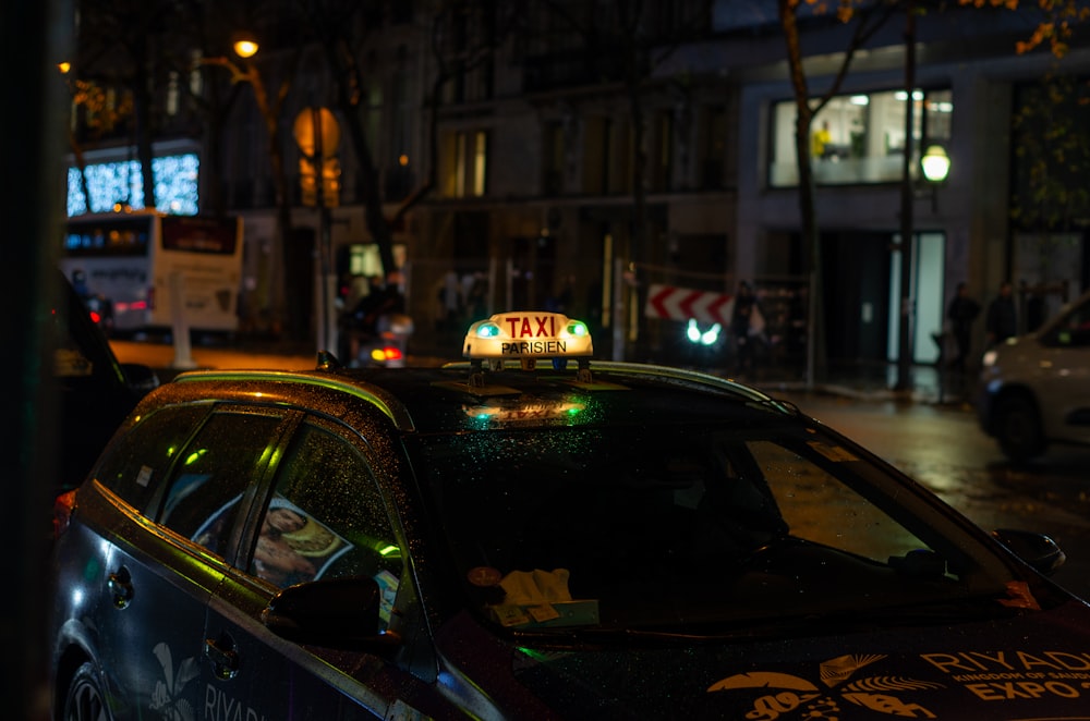 a taxi cab with a yellow taxi sign on top of it