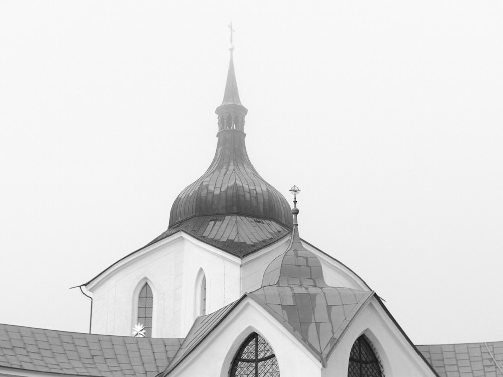 a black and white photo of a church steeple