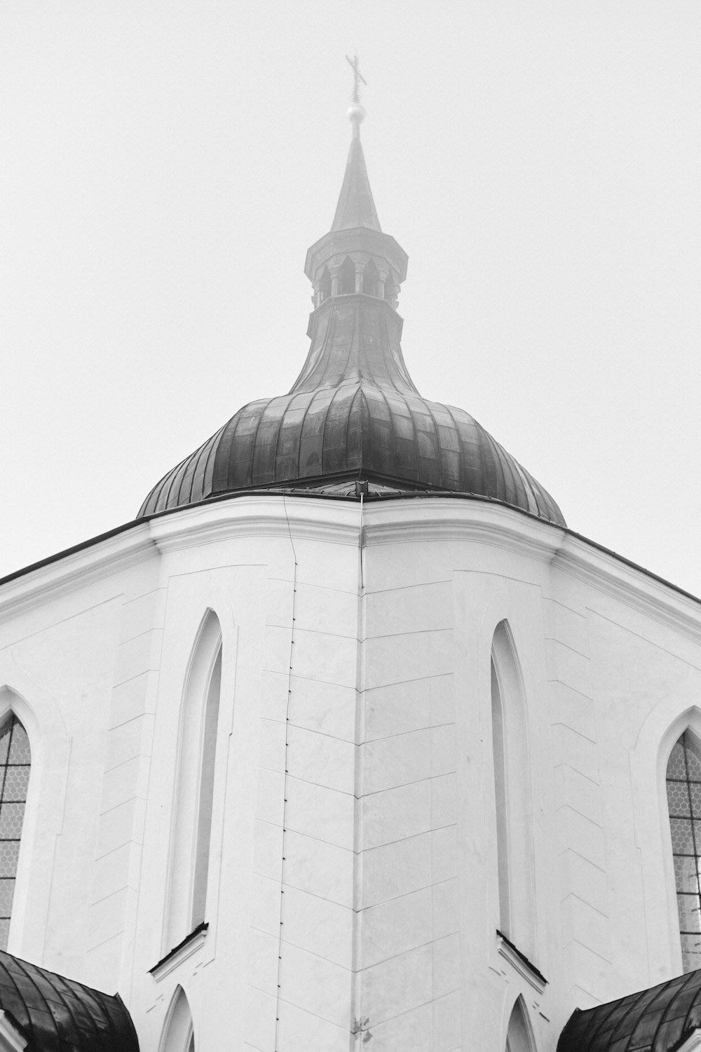 a black and white photo of a church steeple