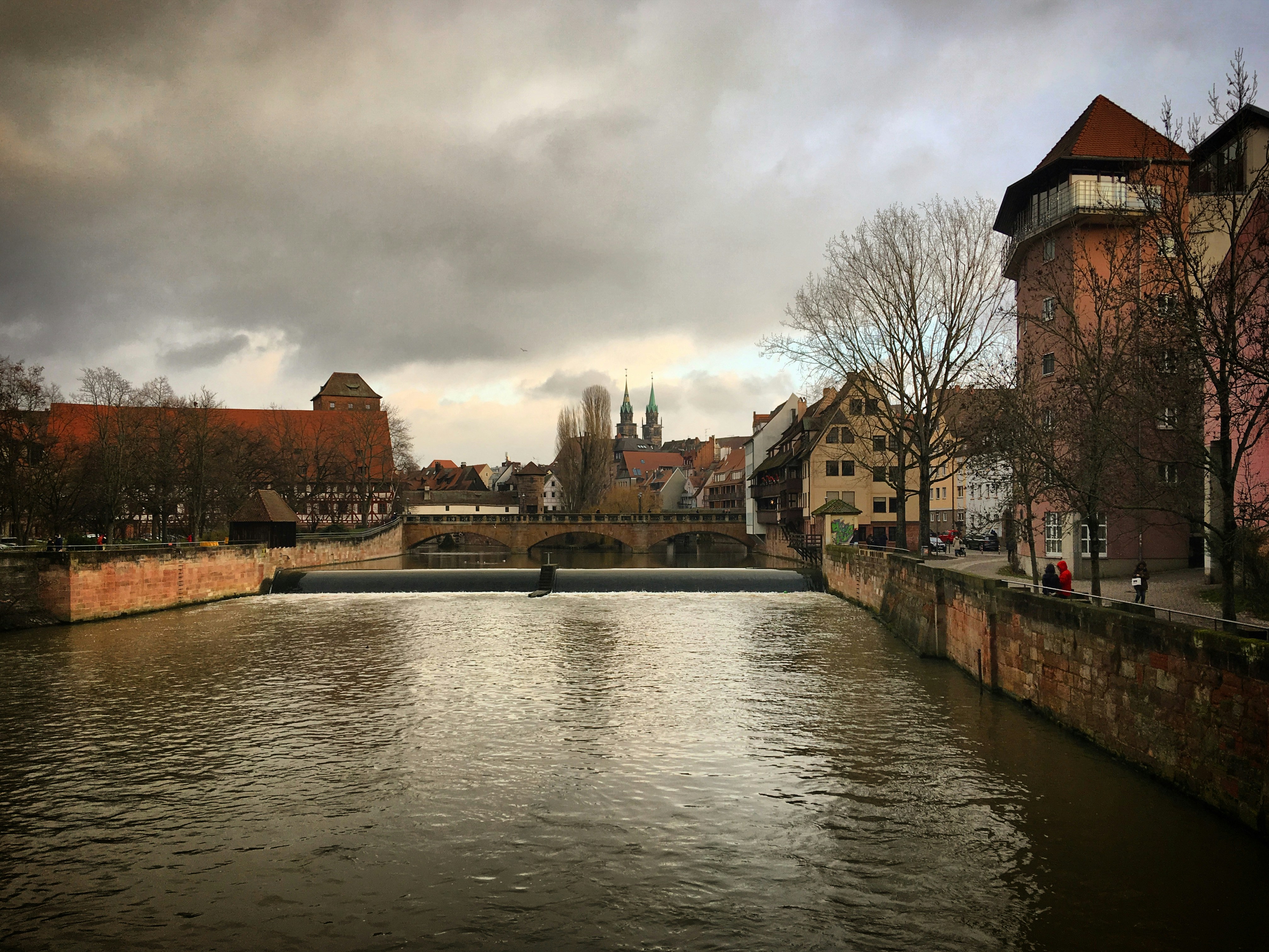 a river running through a city next to tall buildings, River Pegnitz in the old town Nürnberg, Bavaria, Germany, December 2017