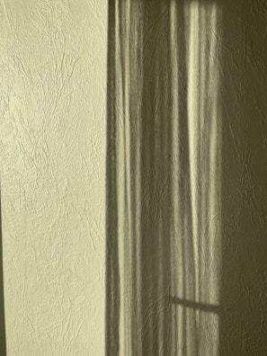 Close-up of textured wall surfaces highlighting the interplay of shadow and light.
