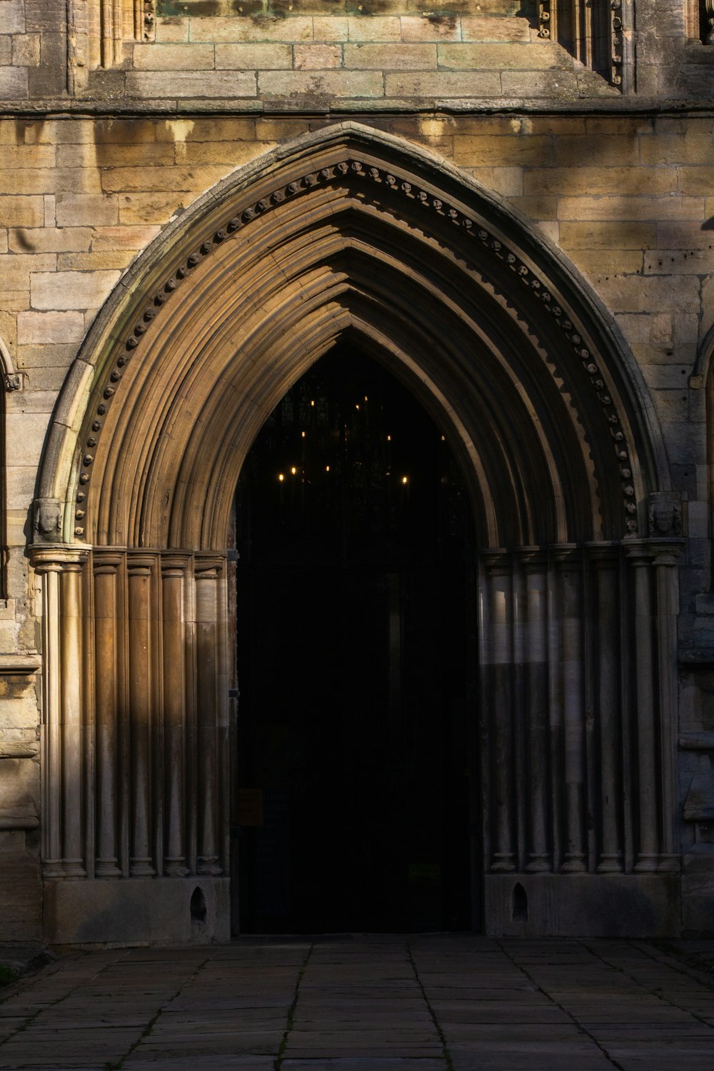 a large stone building with a clock on it's side