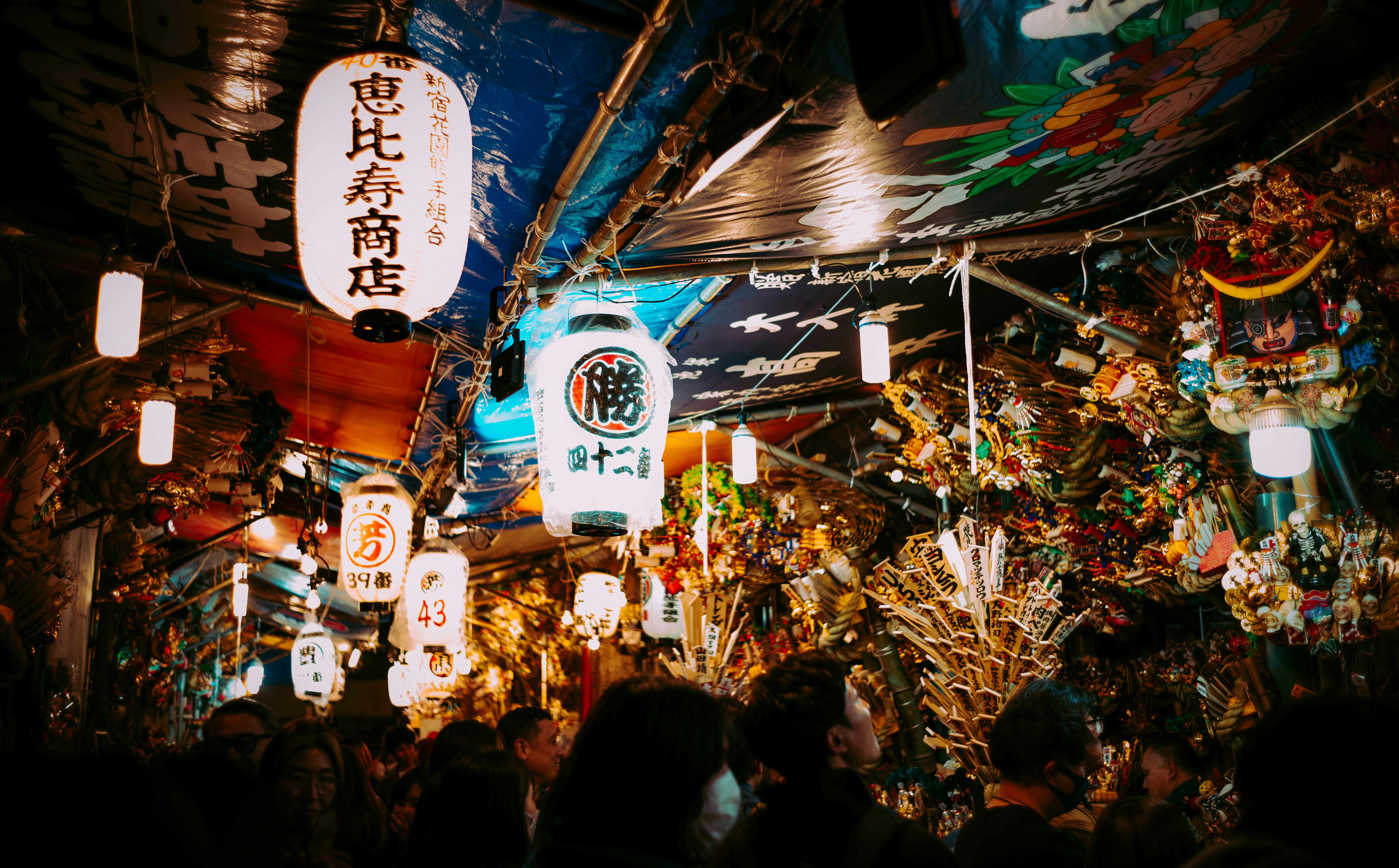 Inside a lively Japanese Izakaya with people toasting