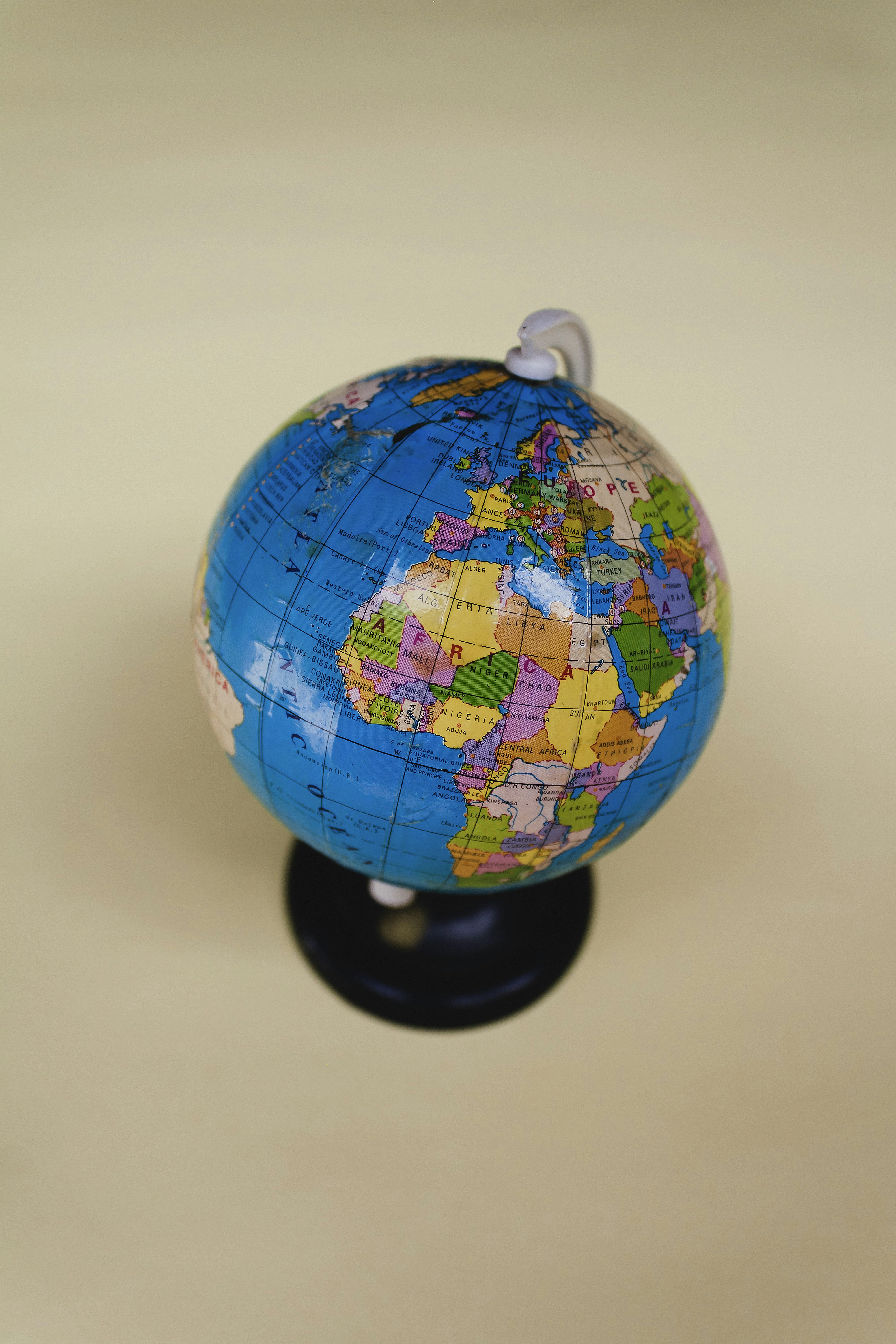 a small blue and yellow globe on a black stand