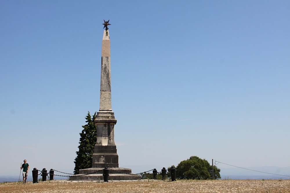 a group of people standing in front of a monument