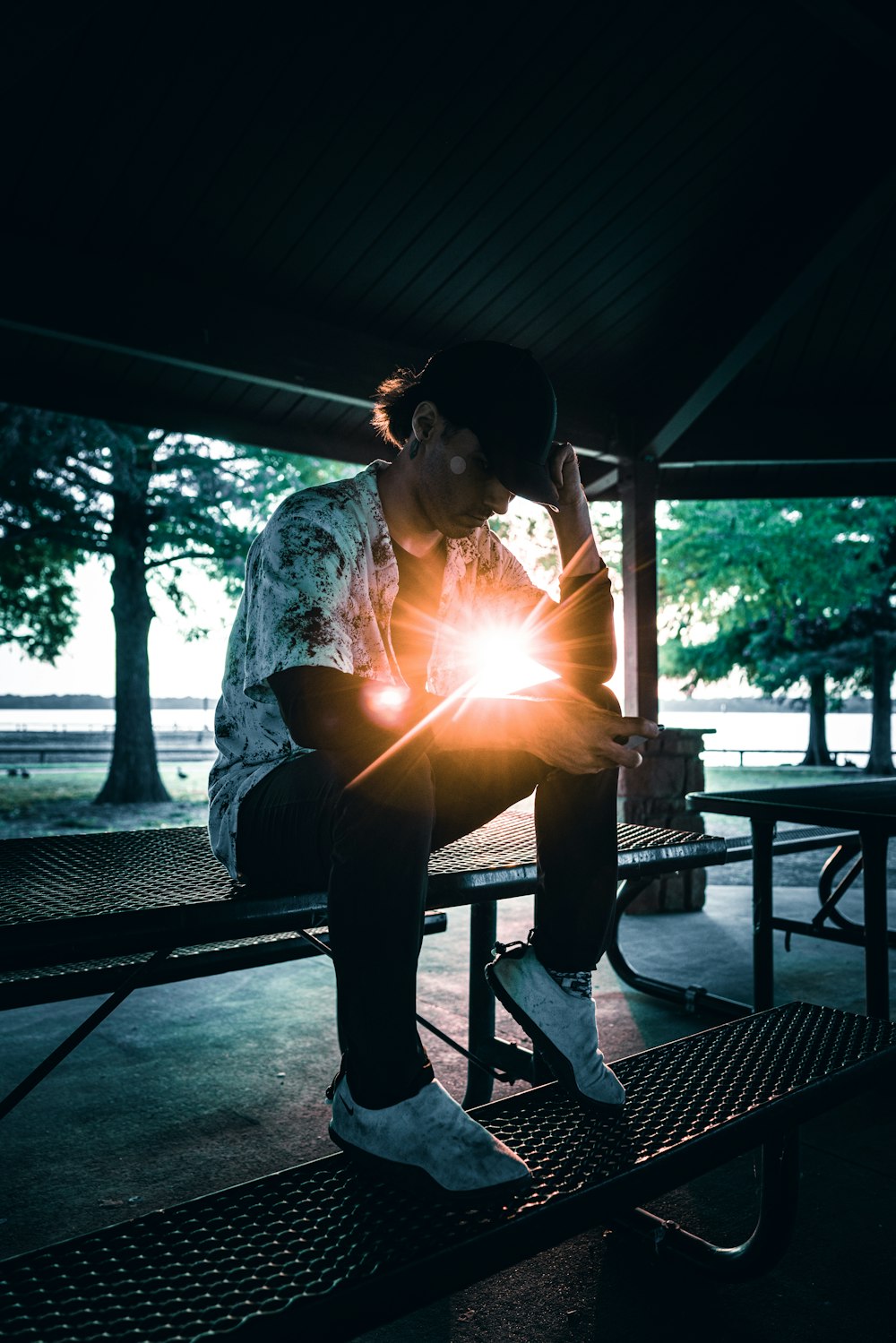 a man sitting on a bench with his head in his hands