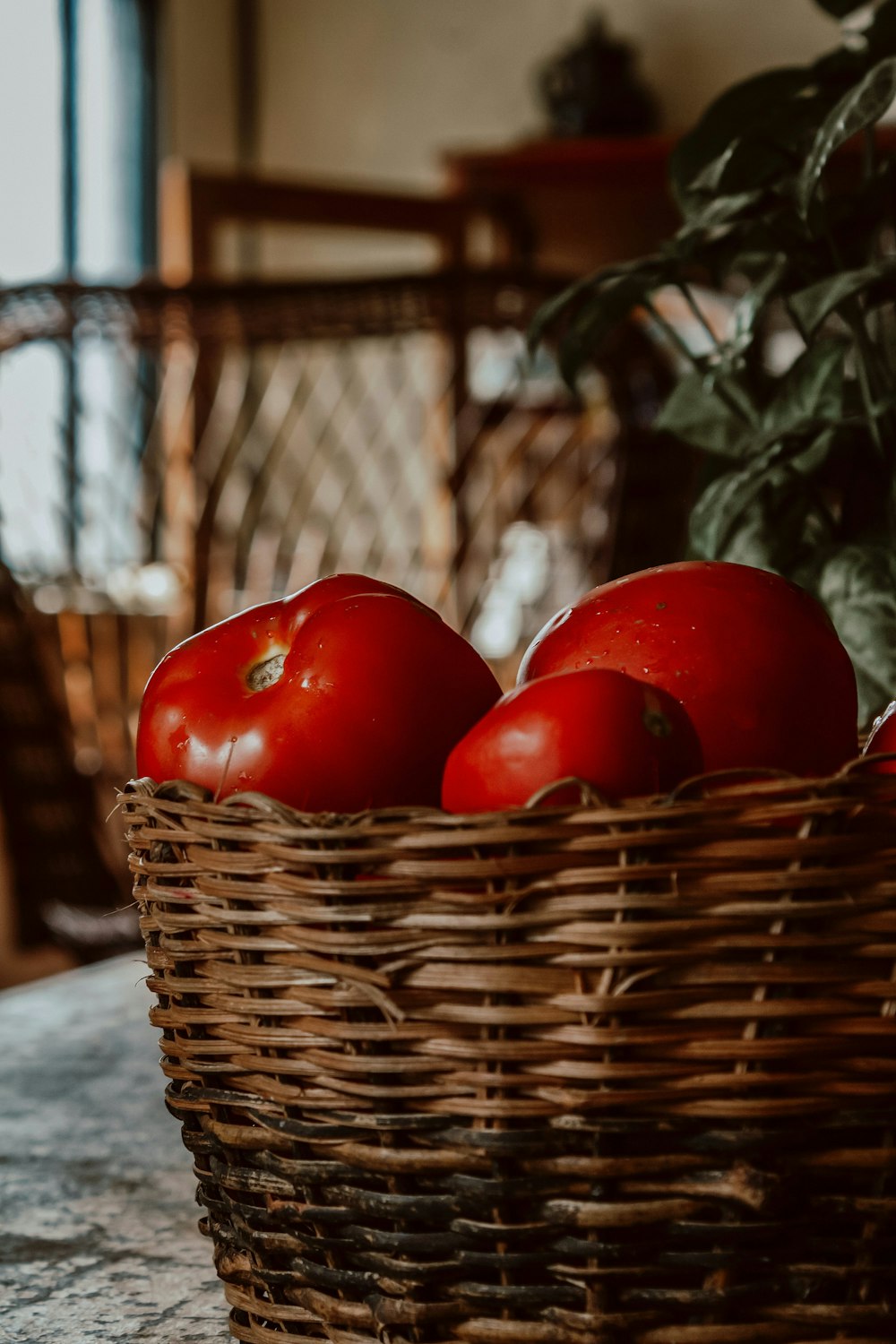 a basket filled with tomatoes sitting on top of a table