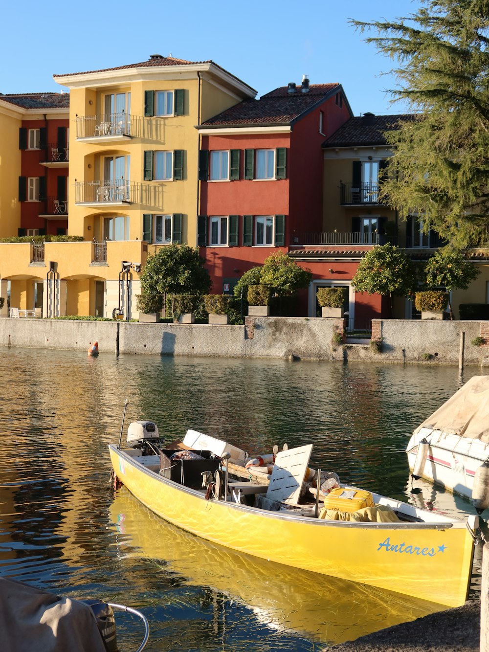 a yellow boat sitting on top of a body of water