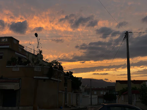 Technician installing fiber optic cables in a residential area at sunset.