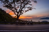 A sunset view over Cartagena with motorcycles parked along the waterfront.