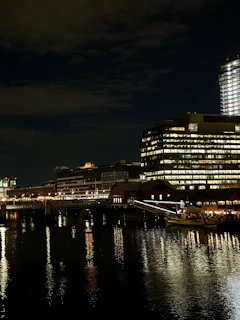 Nighttime shot of illuminated Honeywell Properties towers reflecting on calm waters