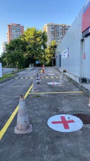 A wide shot of a training session on a road with clear yellow markings and charcoal barriers.