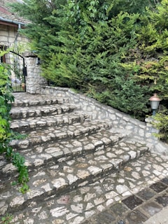 A charming set of custom stone steps leading up to a welcoming front porch.