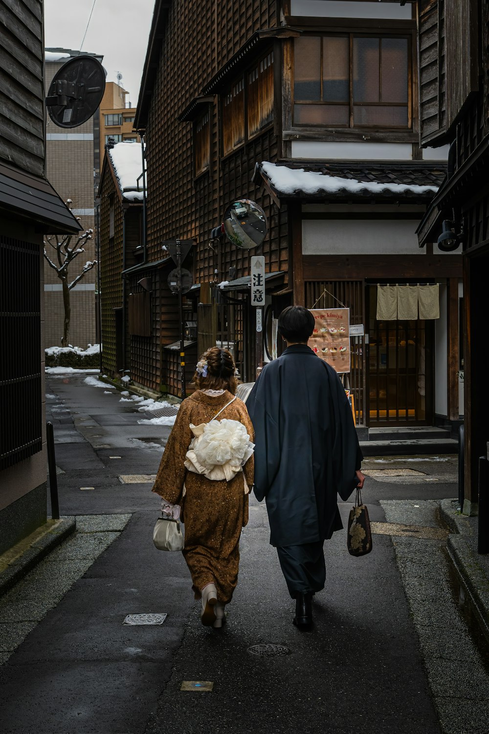 a couple of people walking down a street