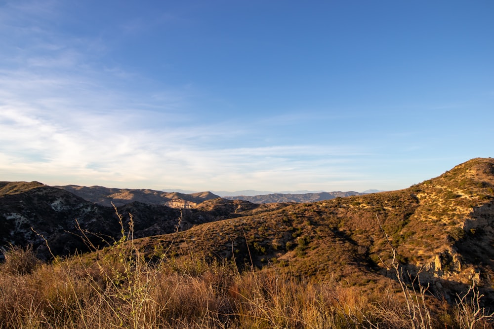 a view of a mountain range with a blue sky in the background