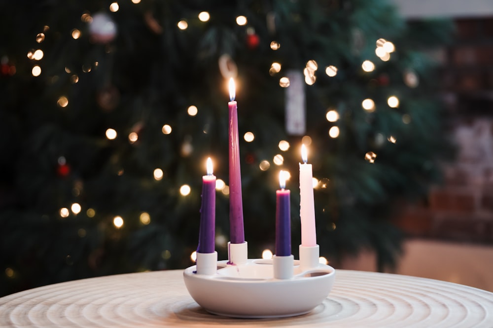 a group of candles sitting on top of a white plate