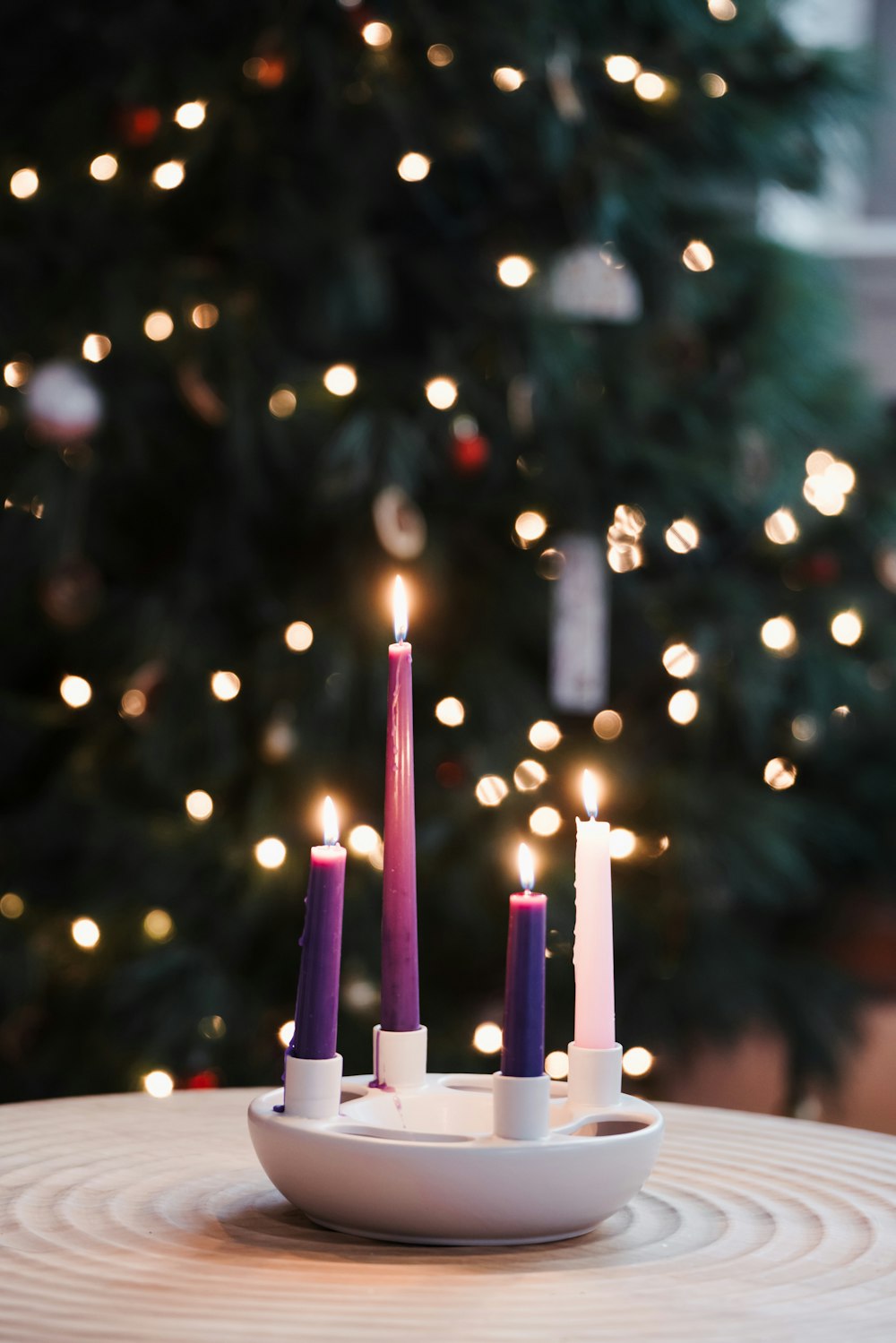 a white plate topped with candles on top of a table