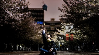 A happy graduate celebrating after securing a job in Japan.