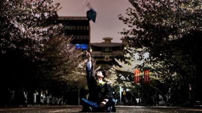 A happy graduate celebrating after securing a job in Japan.