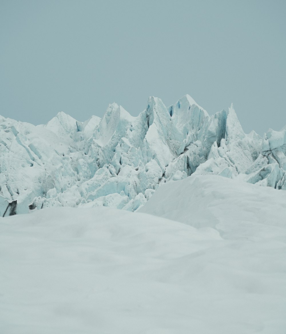 a man riding skis on top of a snow covered slope