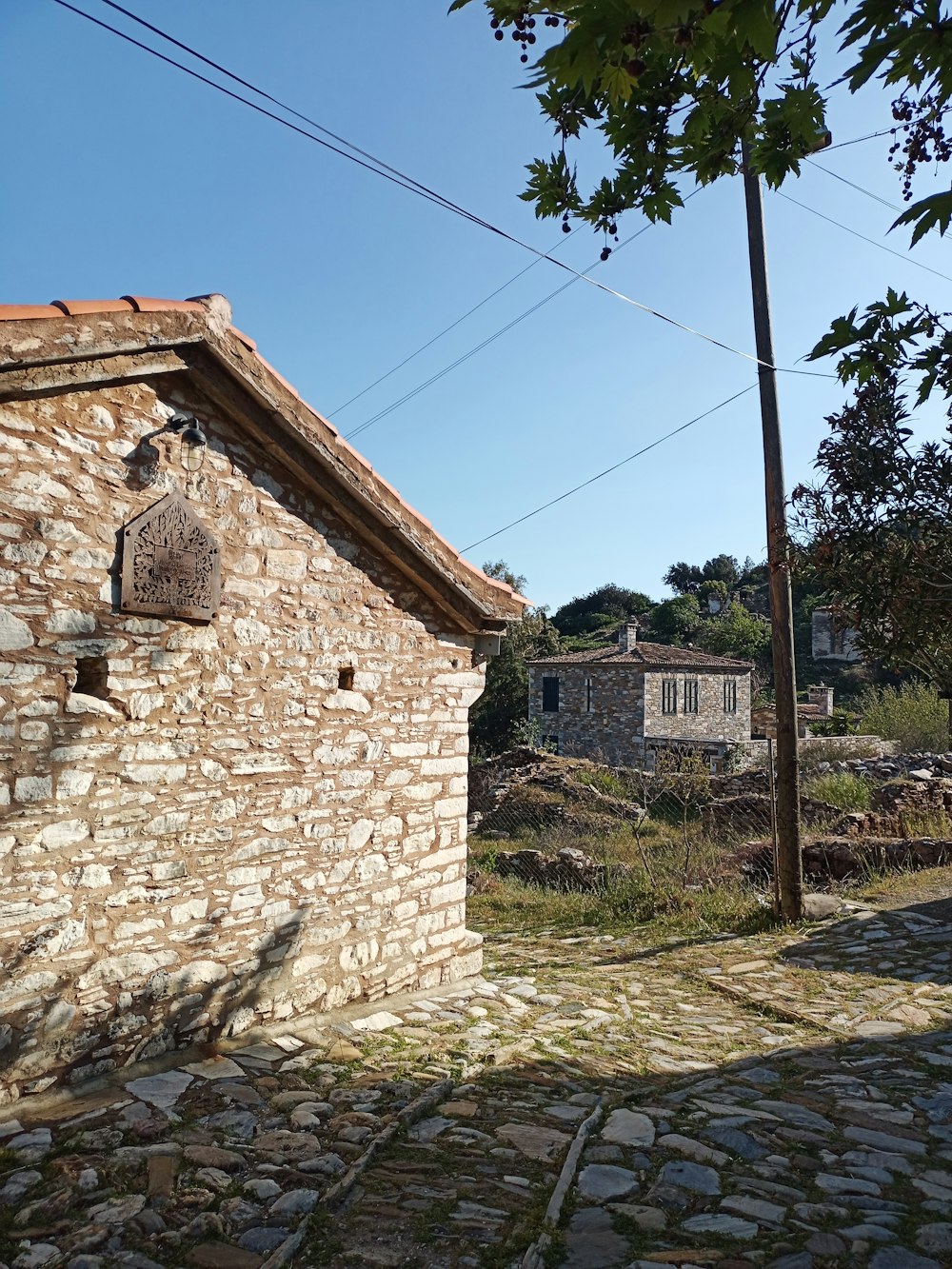 a stone building sitting on the side of a road